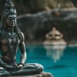 Serene statue of Lord Shiva meditating by tranquil blue water with serene nature background.