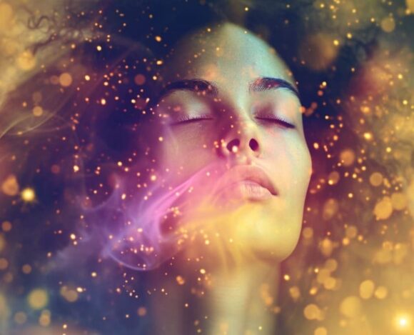 Woman meditating with cosmic energy and stars surrounding her, depicting a spiritual or dream state atmosphere.