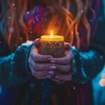 Woman holding sparkling candle in winter setting with festive bokeh lights