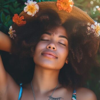 Relaxed woman with flowers in hair enjoying nature