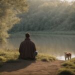 Man sitting by a serene lake with a dog in a peaceful nature setting at dusk.